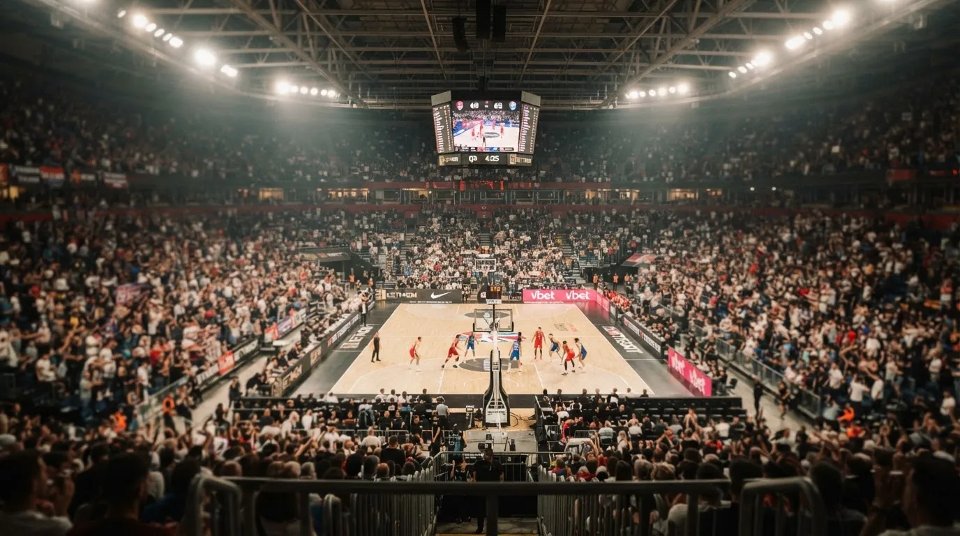 A packed sports hall under floodlights photographed from a long way off